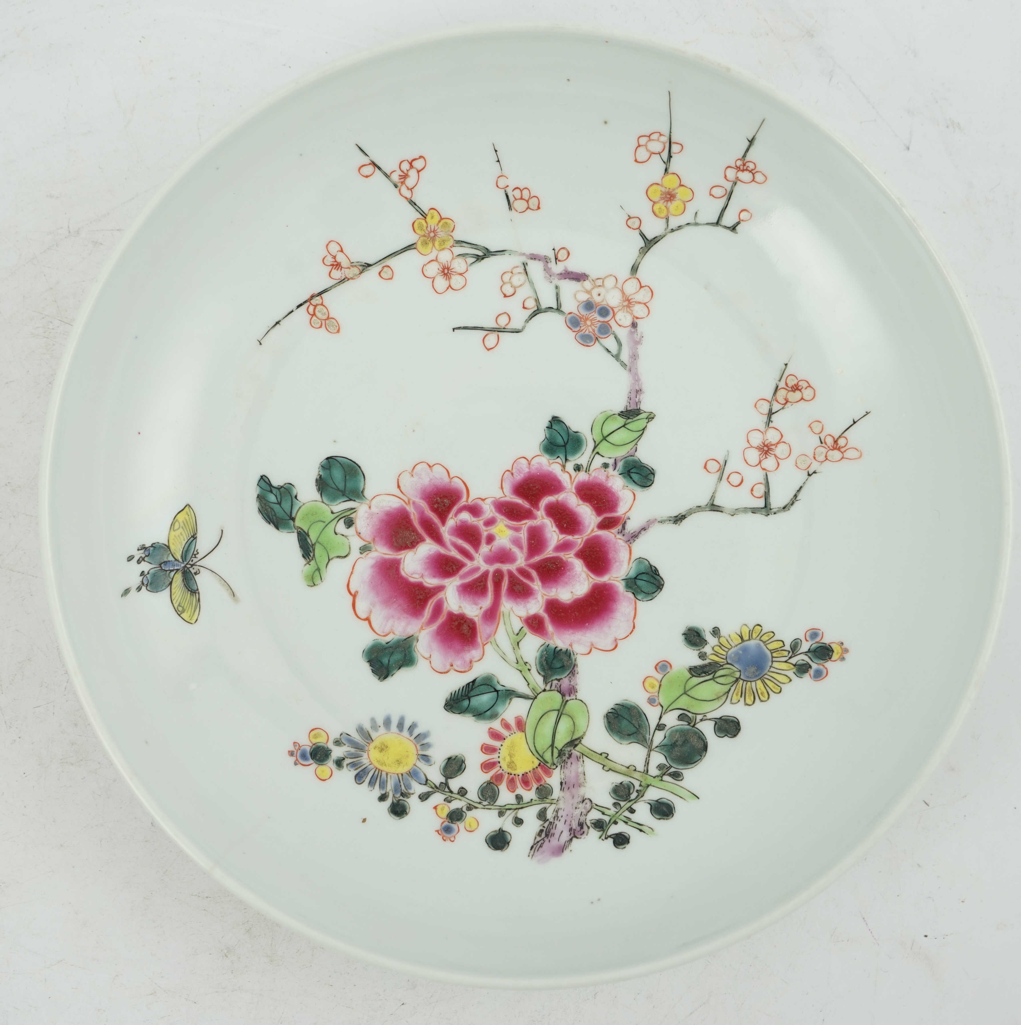 A Chinese famille rose ‘peony and prunus’ saucer dish, Yongzheng mark and period (1723-35)